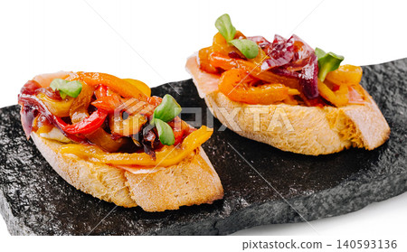 Gourmet bruschetta with roasted peppers and prosciutto Gourmet bruschetta with roasted peppers and prosciutto 140593136