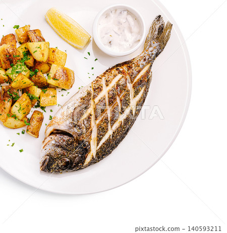 Freshly grilled whole fish with crispy roasted potatoes and tartar sauce Freshly grilled whole fish with crispy roasted potatoes and tartar sauce 140593211