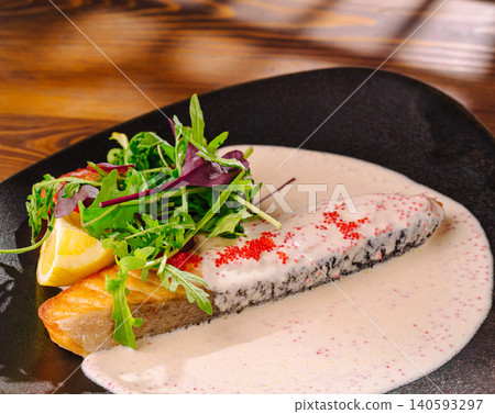 Grilled salmon steak in creamy caviar sauce Grilled salmon steak in creamy caviar sauce 140593297