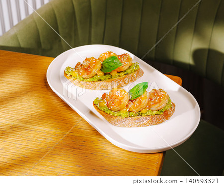 Gourmet avocado toasts with grilled prawns Gourmet avocado toasts with grilled prawns 140593321