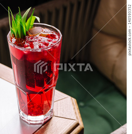Pomegranate cocktail with ice and green leaves Pomegranate cocktail with ice and green leaves 140593352