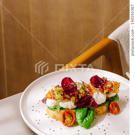 Avocado toast with salmon and poached eggs Avocado toast with salmon and poached eggs 140593367