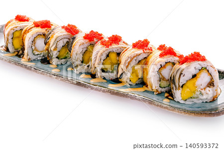 Sushi rolls arranged on a plate with seafood and fruit toppings in a restaurant Sushi rolls arranged on a plate with seafood and fruit toppings in a restaurant 140593372