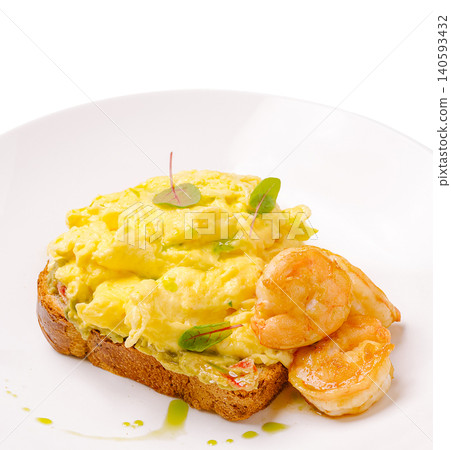 Shrimp and scrambled eggs on toasted bread served with herbs in a dish Shrimp and scrambled eggs on toasted bread served with herbs in a dish 140593432