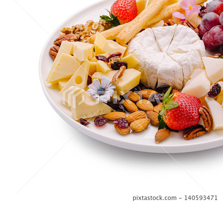 Cheese platter with fruits and nuts arranged on white plate for sharing Cheese platter with fruits and nuts arranged on white plate for sharing 140593471