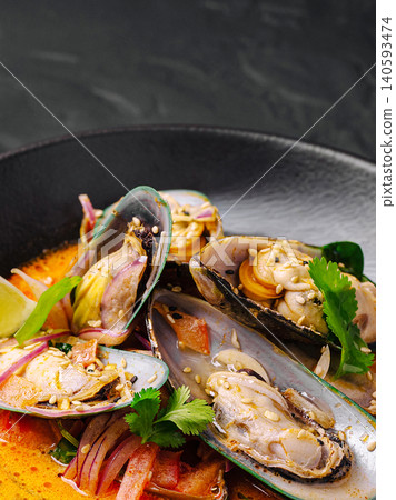 Delicious Thai Coconut Curry Mussels With Cilantro Garnish 140593474