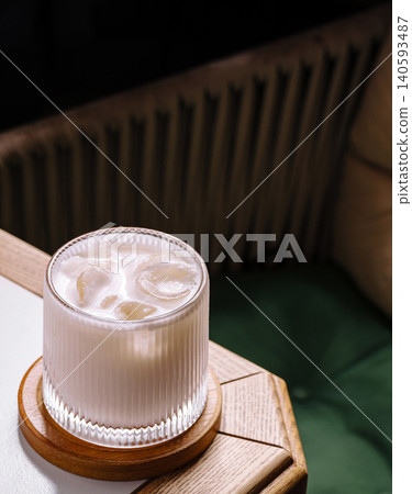 Iced Creamy Milk Drink In Textured Glass On Table 140593487