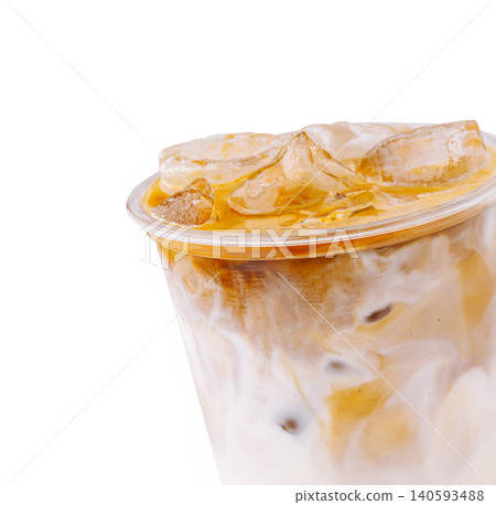 Iced coffee beverage served in clear cup with ice and cream on top 140593488