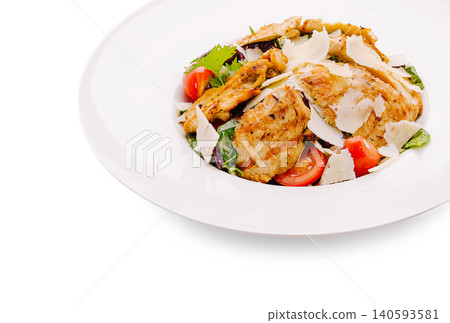 Grilled chicken salad with vegetables and cheese served on a white plate Grilled chicken salad with vegetables and cheese served on a white plate 140593581