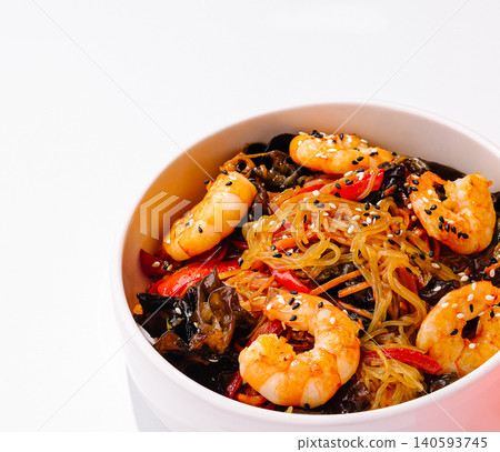 Shrimp and vegetable stir-fry in a bowl with glass noodles and sesame seeds Shrimp and vegetable stir-fry in a bowl with glass noodles and sesame seeds 140593745