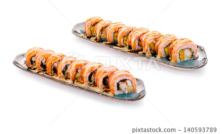 Sushi rolls with shrimp and avocado served on plates at a restaurant Sushi rolls with shrimp and avocado served on plates at a restaurant 140593789