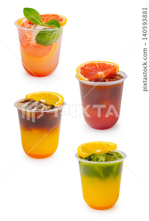 Drinks served in clear cups with colorful layers and fruit garnishes Drinks served in clear cups with colorful layers and fruit garnishes 140593881