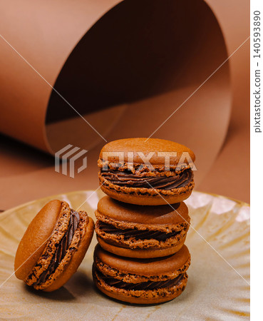 Brown macarons on a plate with a simple background in a kitchen setting Brown macarons on a plate with a simple background in a kitchen setting 140593890