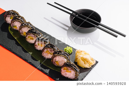 Sushi rolls on a black plate with chopsticks and soy sauce bowl Sushi rolls on a black plate with chopsticks and soy sauce bowl 140593928