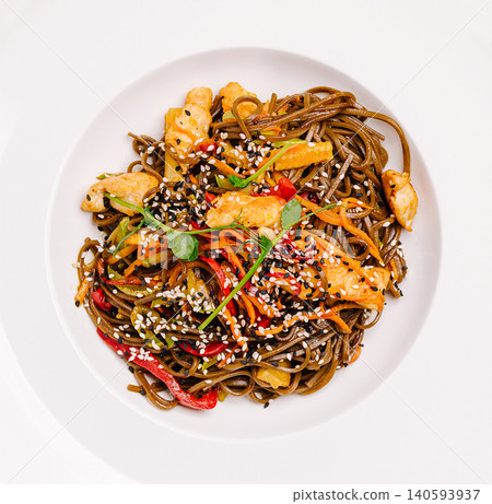 Noodles with chicken and vegetables served in a white bowl Noodles with chicken and vegetables served in a white bowl 140593937