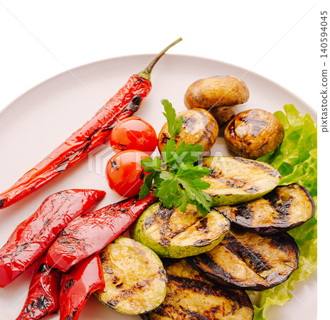 Grilled vegetables on a plate with fresh herbs, tomatoes, and chili peppers Grilled vegetables on a plate with fresh herbs, tomatoes, and chili peppers 140594045