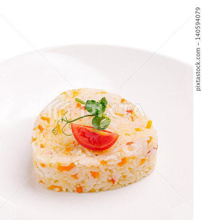 Heart shaped rice served with tomato and garnish on white plate 140594079
