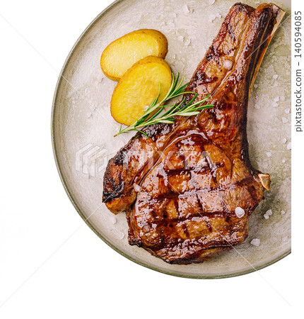 Grilled meat served with roast potatoes on a round plate Grilled meat served with roast potatoes on a round plate 140594085