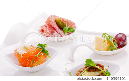 Small dishes with various food items served on a white platter Small dishes with various food items served on a white platter 140594101