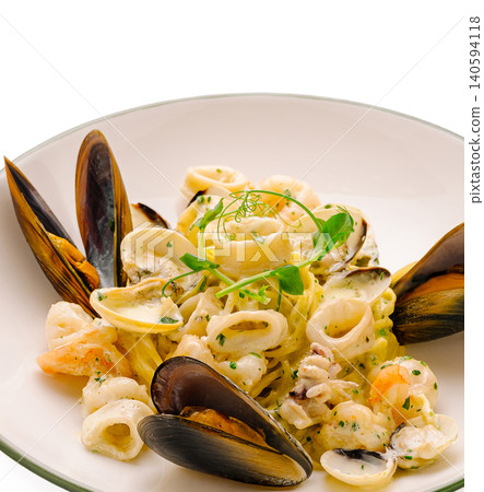 Pasta dish with seafood served in a large white bowl Pasta dish with seafood served in a large white bowl 140594118