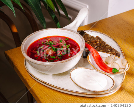 Traditional soup served with bread and toppings in a cozy setting Traditional soup served with bread and toppings in a cozy setting 140594120