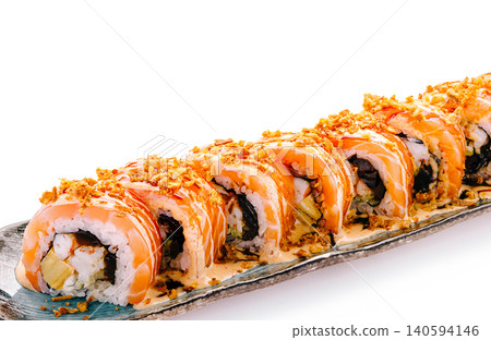 Sushi roll with shrimp and crunchy topping served on a platter 140594146