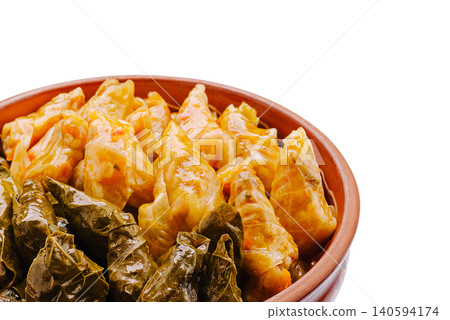 Delicious stuffed grape leaves and cabbage rolls served together in a bowl Delicious stuffed grape leaves and cabbage rolls served together in a bowl 140594174