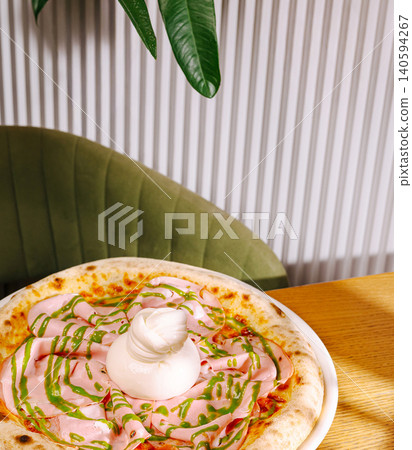 Fresh pizza with toppings on a wooden table in a cozy restaurant setting Fresh pizza with toppings on a wooden table in a cozy restaurant setting 140594267