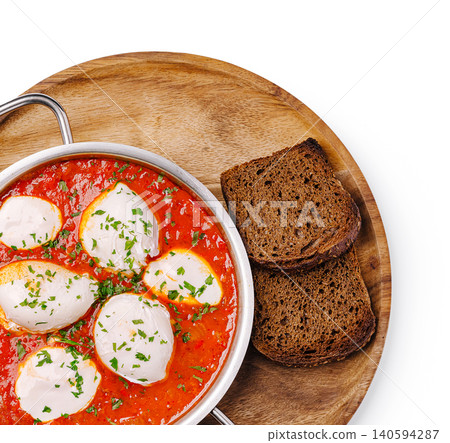 Delicious dish served with bread on a wooden board in bright setting Delicious dish served with bread on a wooden board in bright setting 140594287