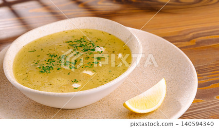 Traditional Hot Chicken Soup Served With Fresh Lemon Traditional Hot Chicken Soup Served With Fresh Lemon 140594340