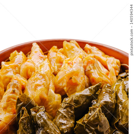Stuffed grape leaves and cabbage rolls on a plate at a dinner gathering Stuffed grape leaves and cabbage rolls on a plate at a dinner gathering 140594344