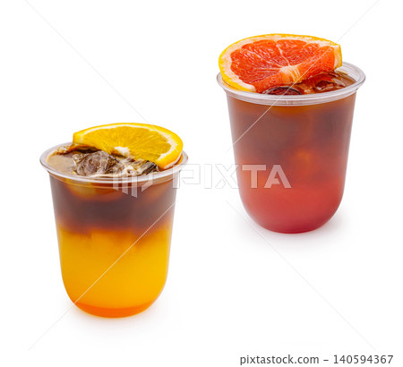 Cold drinks in clear cups with ice and fruit slices on a white background Cold drinks in clear cups with ice and fruit slices on a white background 140594367