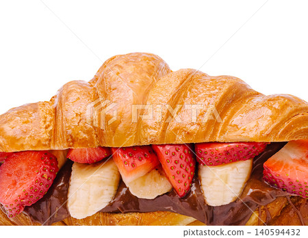 Croissant filled with chocolate, strawberries, and bananas on a white background Croissant filled with chocolate, strawberries, and bananas on a white background 140594432
