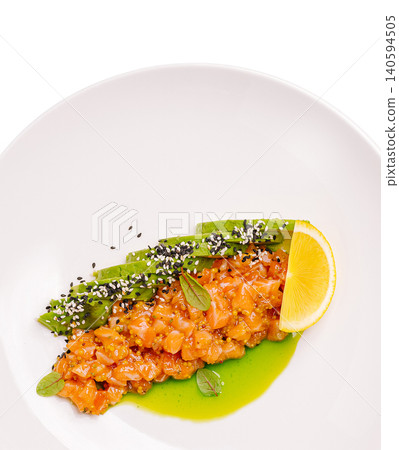 Salmon tartare with avocado and lemon served in a white bowl Salmon tartare with avocado and lemon served in a white bowl 140594505