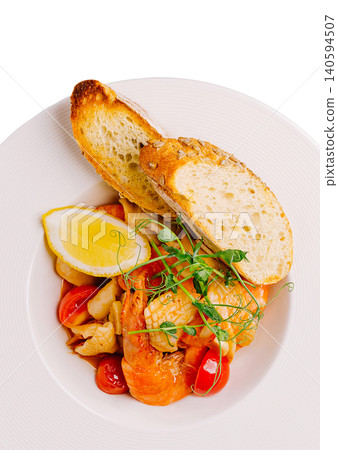 Delicious seafood dish with shrimp, tomatoes, and bread on a plate Delicious seafood dish with shrimp, tomatoes, and bread on a plate 140594507