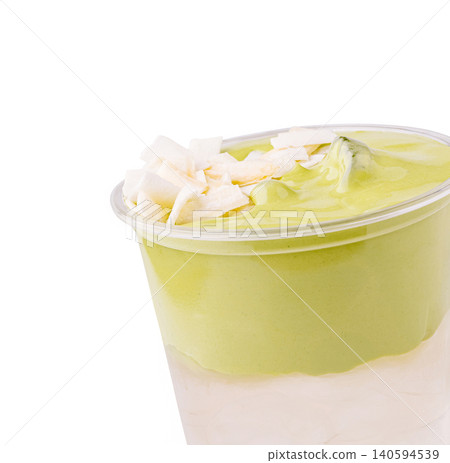 Iced matcha dalgona latte with coconut flakes topping Iced matcha dalgona latte with coconut flakes topping 140594539