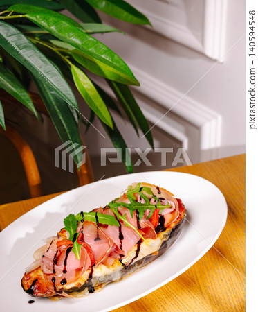 Baked eggplant boat with prosciutto ham and balsamic glaze Baked eggplant boat with prosciutto ham and balsamic glaze 140594548