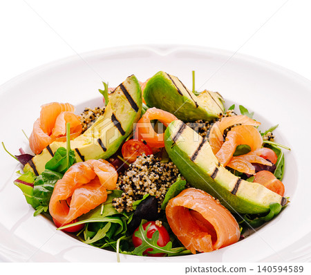 Healthy salad with salmon and avocado served in a white bowl Healthy salad with salmon and avocado served in a white bowl 140594589