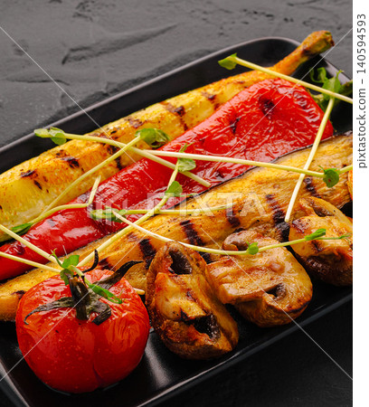 Grilled vegetables on a black plate served in a restaurant 140594593