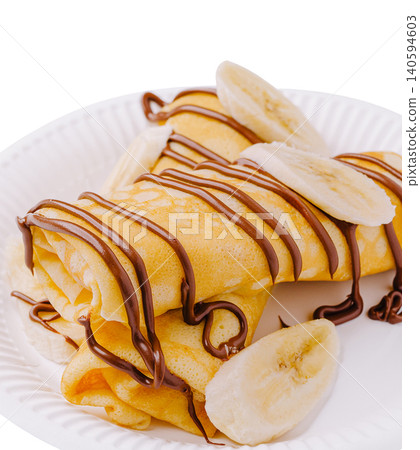 Delicious crepes with chocolate and banana served on a paper plate Delicious crepes with chocolate and banana served on a paper plate 140594603