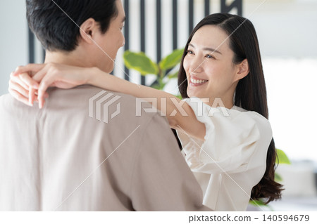 A middle-aged couple relaxing in the living room A middle-aged couple relaxing in the living room 140594679