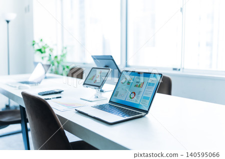 Laptop working in a brightly lit office 140595066