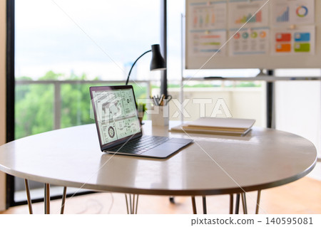 A laptop on a desk and an office scene A laptop on a desk and an office scene 140595081