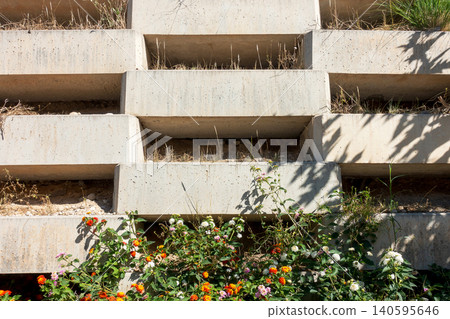 Decorative Concrete Block Wall with Flowers and Greenery Decorative Concrete Block Wall with Flowers and Greenery 140595646