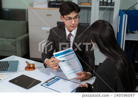 Legal counsel presents to the client a signed contract with legal law. justice and lawyer concept in office. 140596097