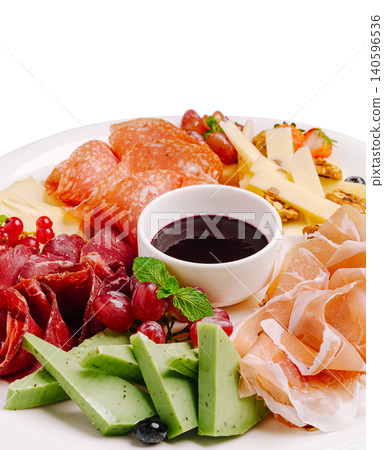 Charcuterie board with cheese, various meats, fruits, and sauce Charcuterie board with cheese, various meats, fruits, and sauce 140596536