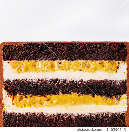 Chocolate cake showing layers of cream and caramel filling 140596543