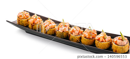 Baked tempura sushi rolls with salmon on black plate Baked tempura sushi rolls with salmon on black plate 140596553