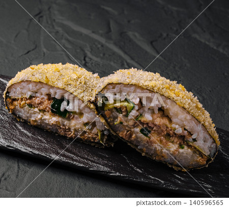 Fried sushi roll with tuna, cucumber, and rice on slate Fried sushi roll with tuna, cucumber, and rice on slate 140596565
