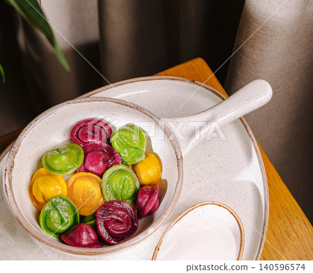 Colorful dumplings pelmeni in ceramic bowl 140596574